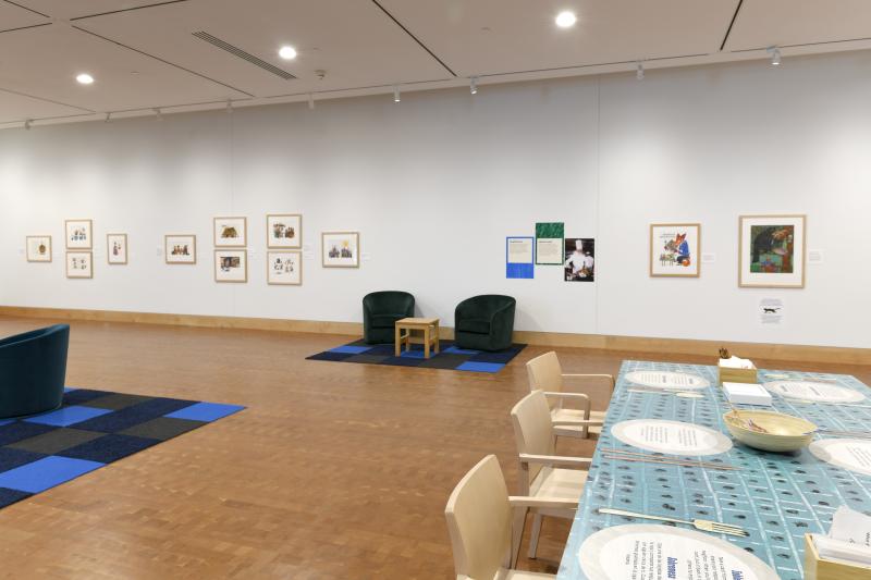 Photograph of gallery showing framed art and graphics.