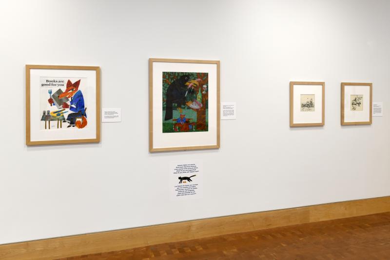 Photograph of gallery showing framed art and graphics.