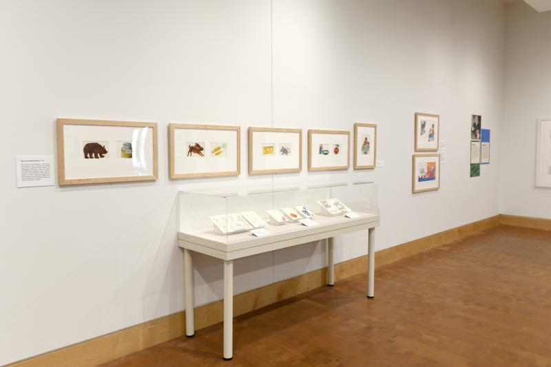 Photograph of gallery showing framed art and graphics.