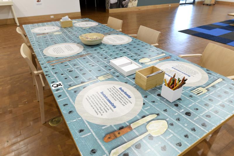 Photograph of gallery showing framed art and graphics.