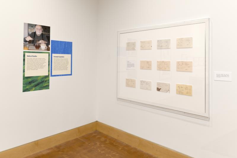 Photograph of gallery showing framed art and graphics.