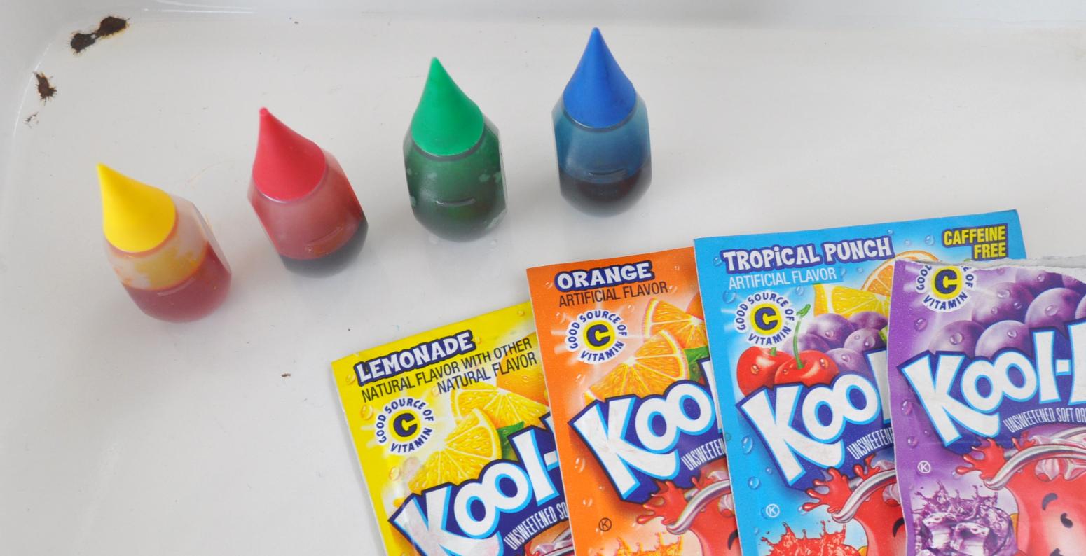 Food coloring bottles and Kool-Aid packets.