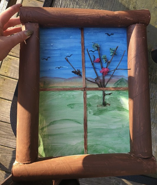 Image of a painted outdoor scene with a cardboard tube frame