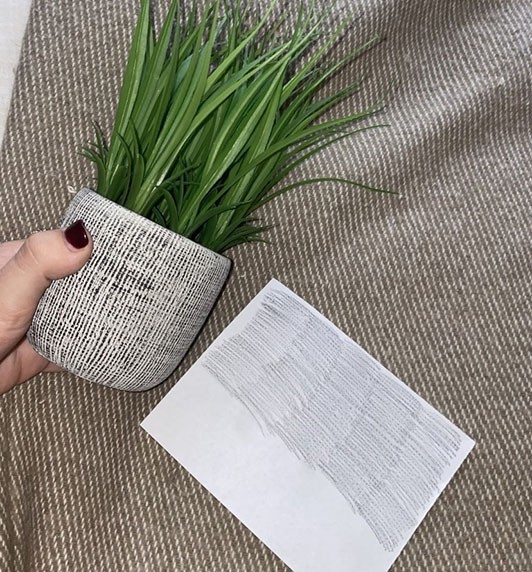 Planter with rough texture next to a paper showing the transfer of that texture.