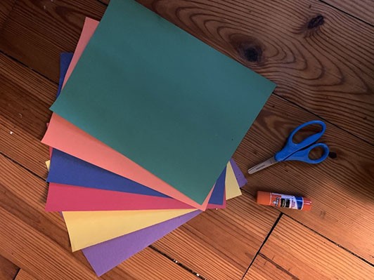 variety of colorful pieces of construction paper, scissors, and glue.