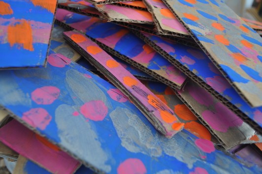 (A pile of colorfully painted cardboard pieces
