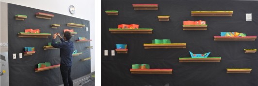 Two images of a display wall with books on cardboard shelves.