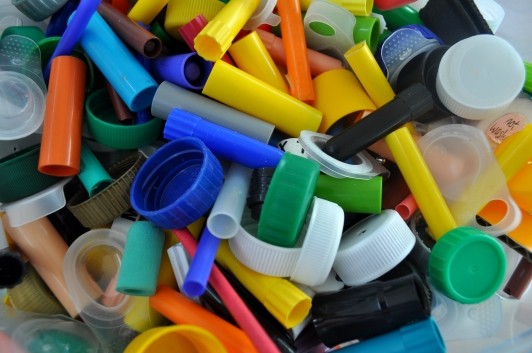 A pile of various colorful plastic caps and lids.