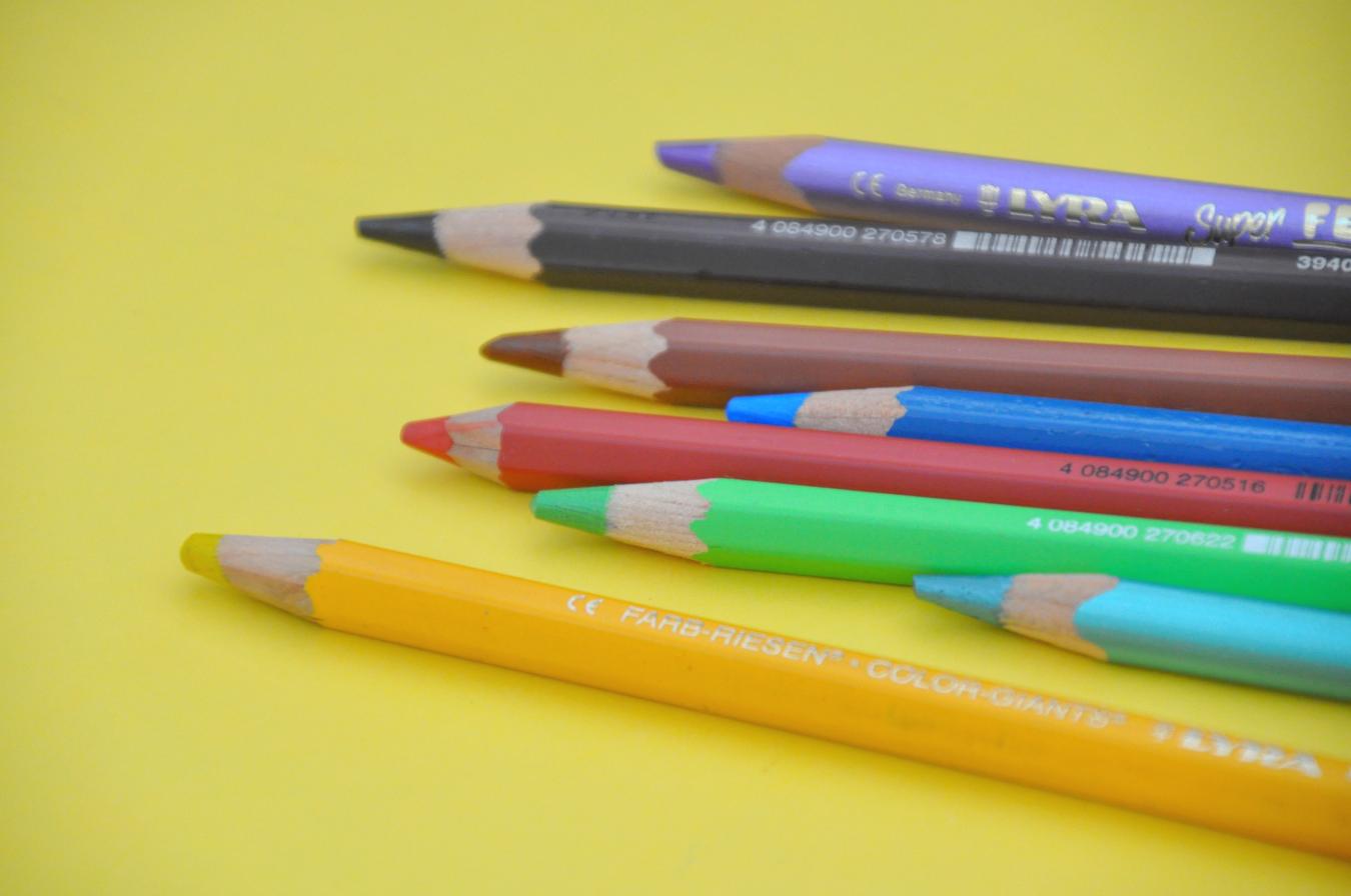 Several colorful colored pencils lined up next to each other.