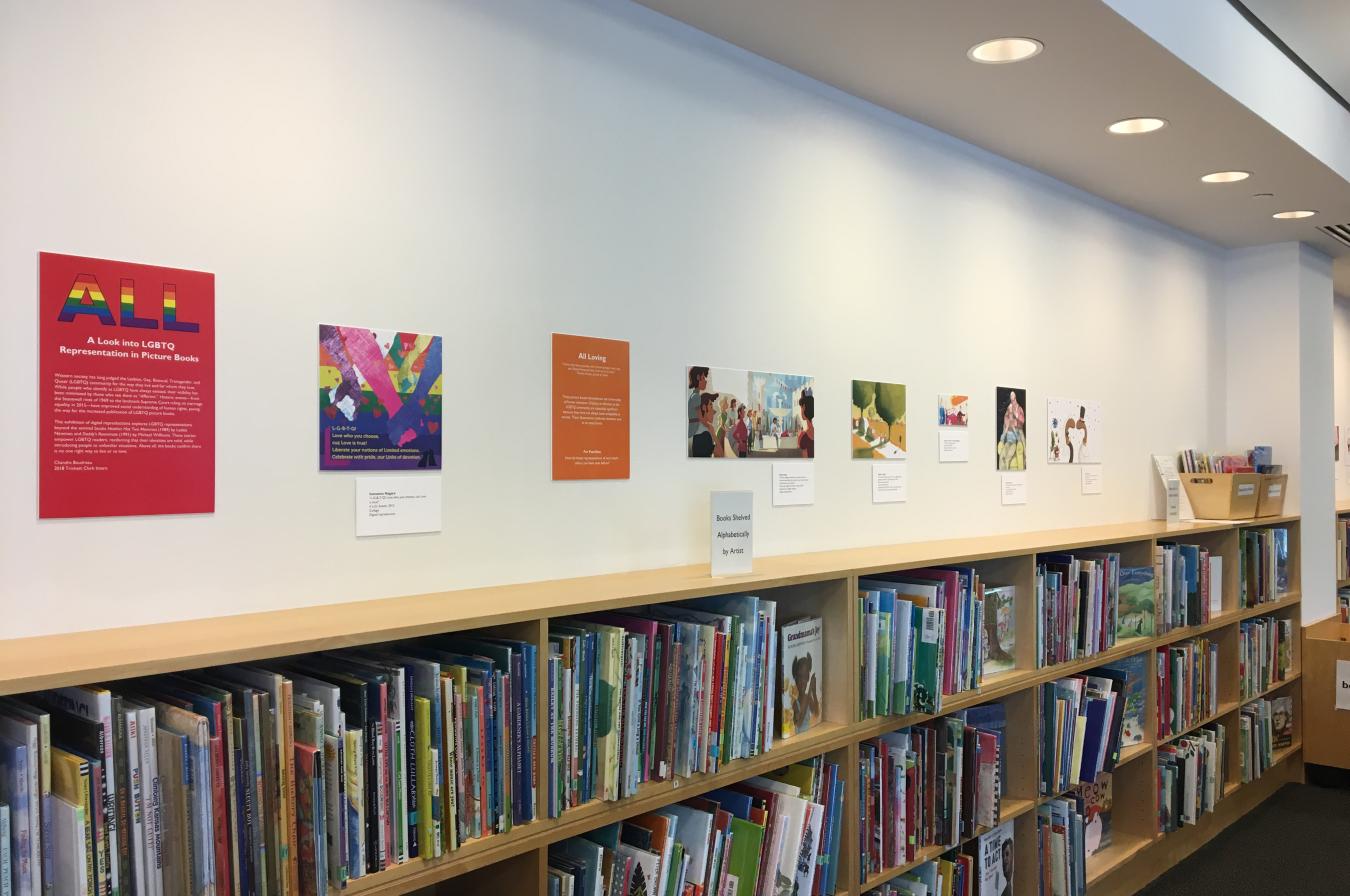 The image reproductions from the 2018 version of ALL: A Look into LGBTQ Representation in Picture Books hanging in the Reading Library.