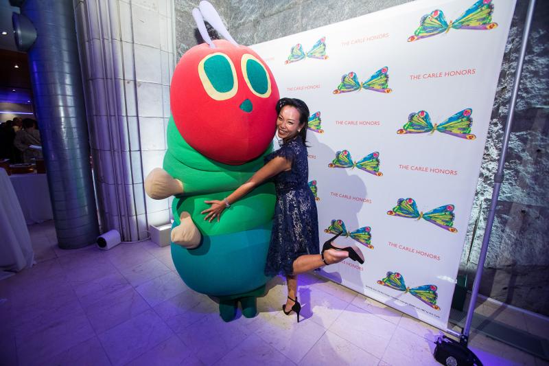 Carle Honors guest hugging the costumed Very Hungry Caterpillar