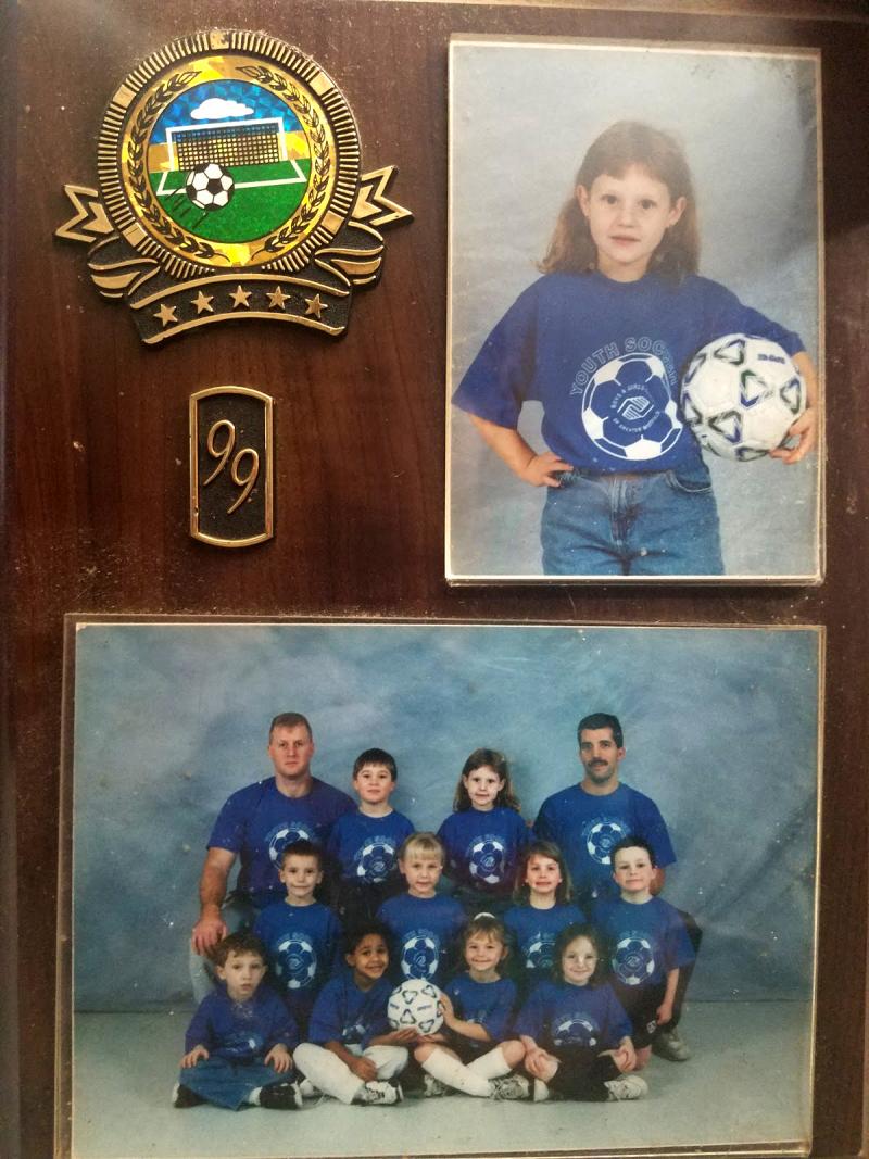 Award with medallion and photo of a soccer team.