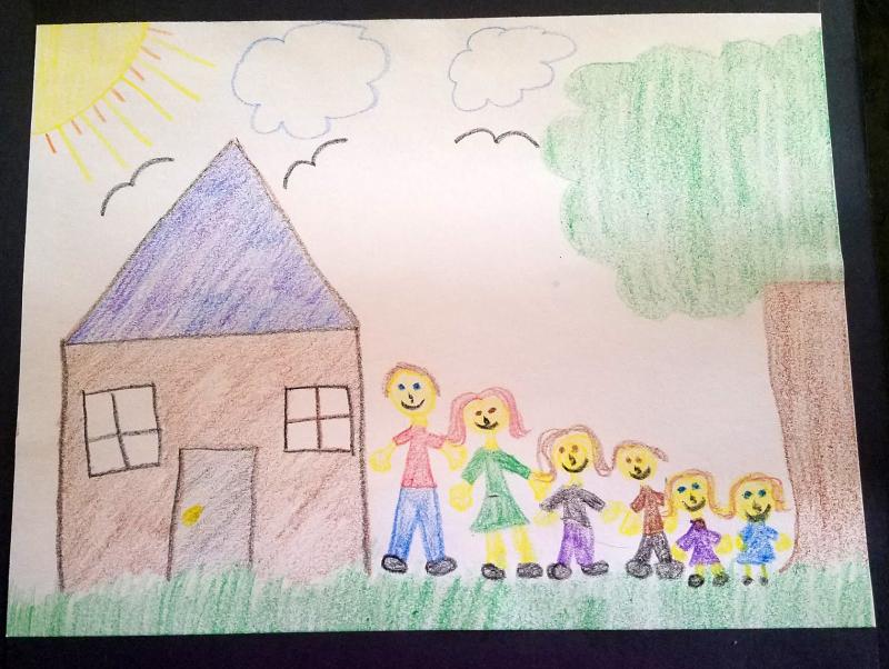 Drawing of a family standing together outside of a house.