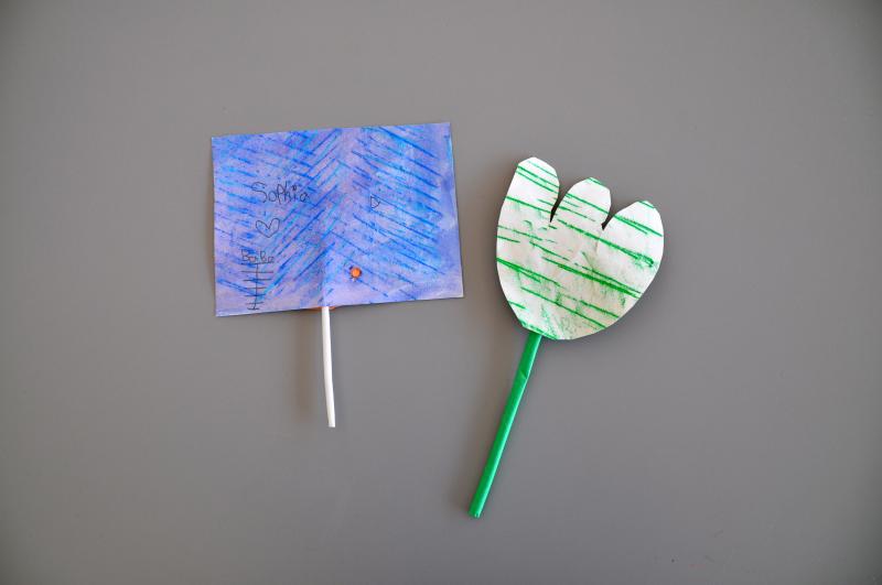Cut-out paper shapes attached to straws