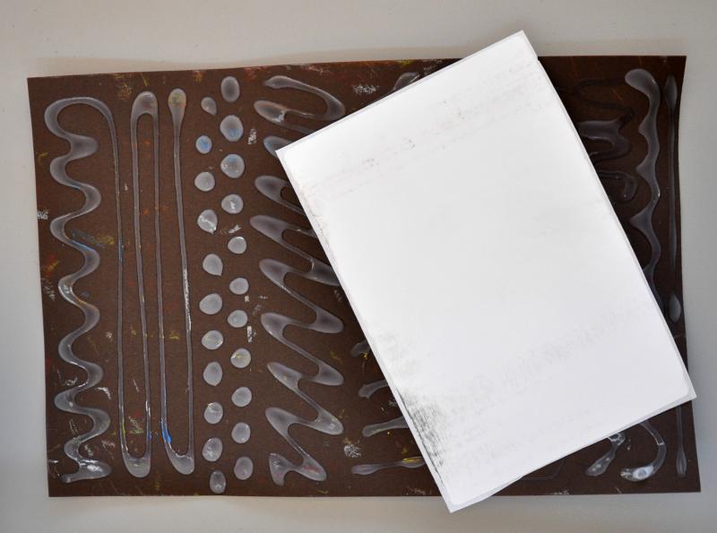 textured rubbing plate with large sticker label on top