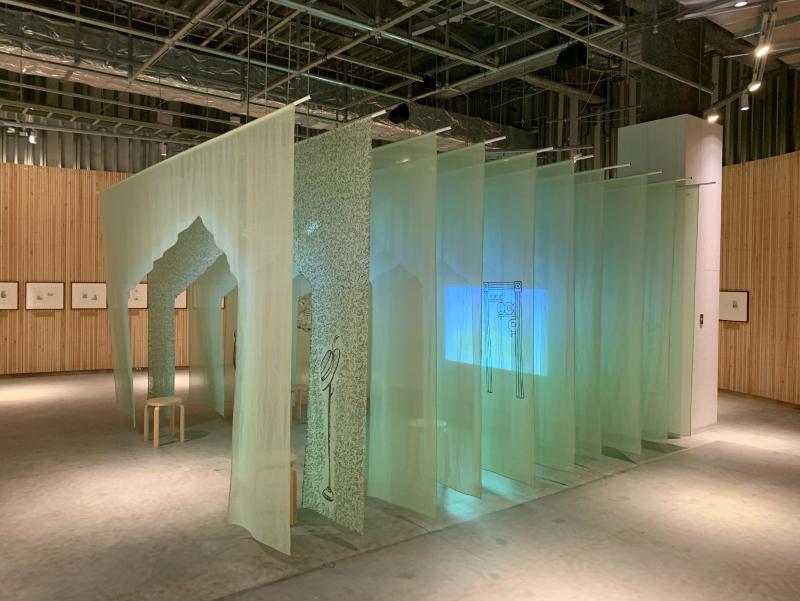 Installation image showing walls with framed art.