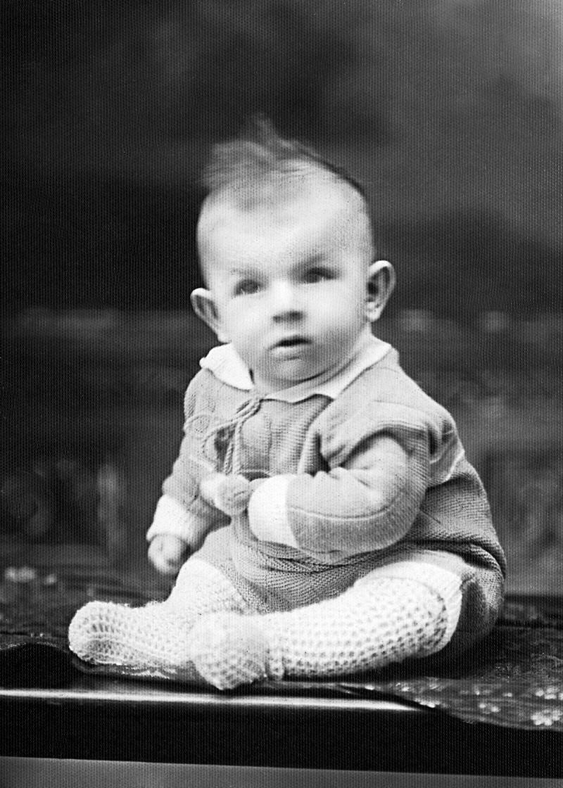 black and white image of baby sitting