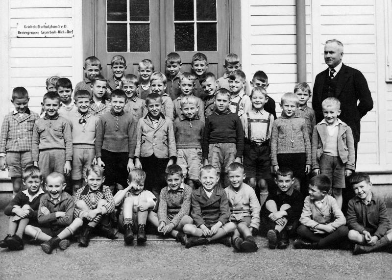 black and white class photo of boys with their teacher