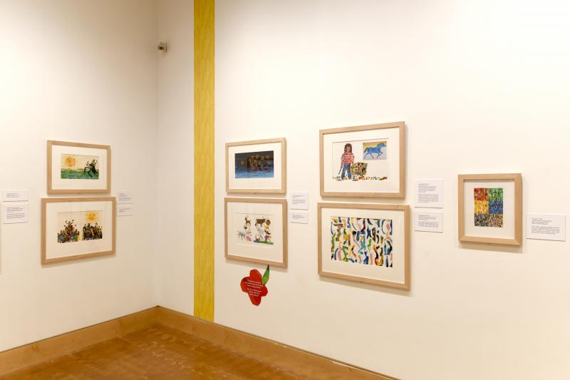 Installation image showing walls with framed art.