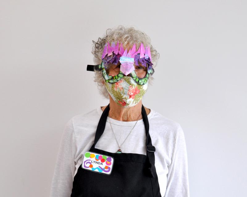 Art Studio team member wearing collage paper glasses