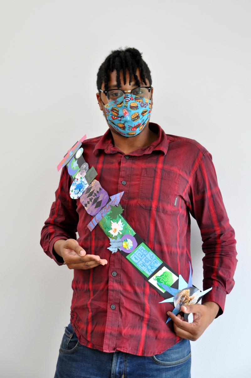 Art Studio team member wearing collage paper sash