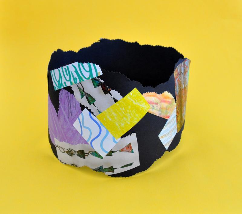 paper looped into a circle shape and embellished with colorful stickers.
