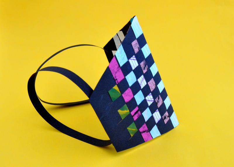 Woven paper arm-band with colorful collage paper.