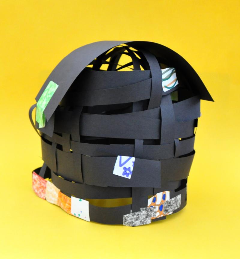 Helmet made from paper woven together and stickers.