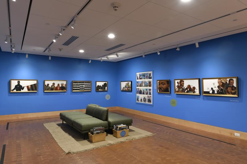 Photograph of paintings hanging on wall in gallery
