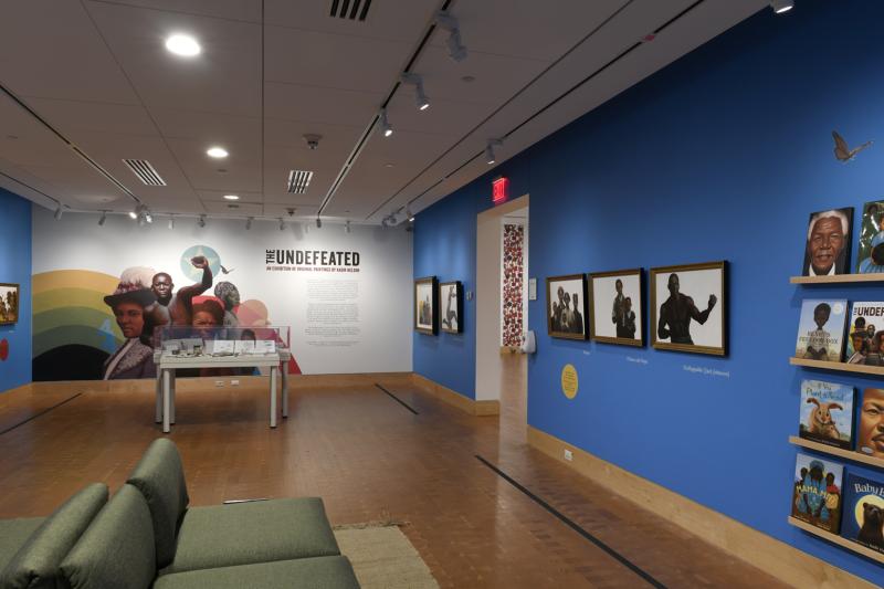 Photograph of paintings hanging on wall in gallery