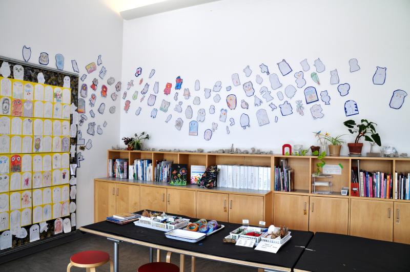 Display of drawn owls extending around the corner and onto a second wall.