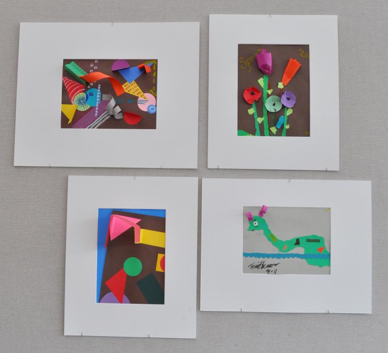 Four artworks with paper collages and sculptures including flowers, fish, and abstract shapes.