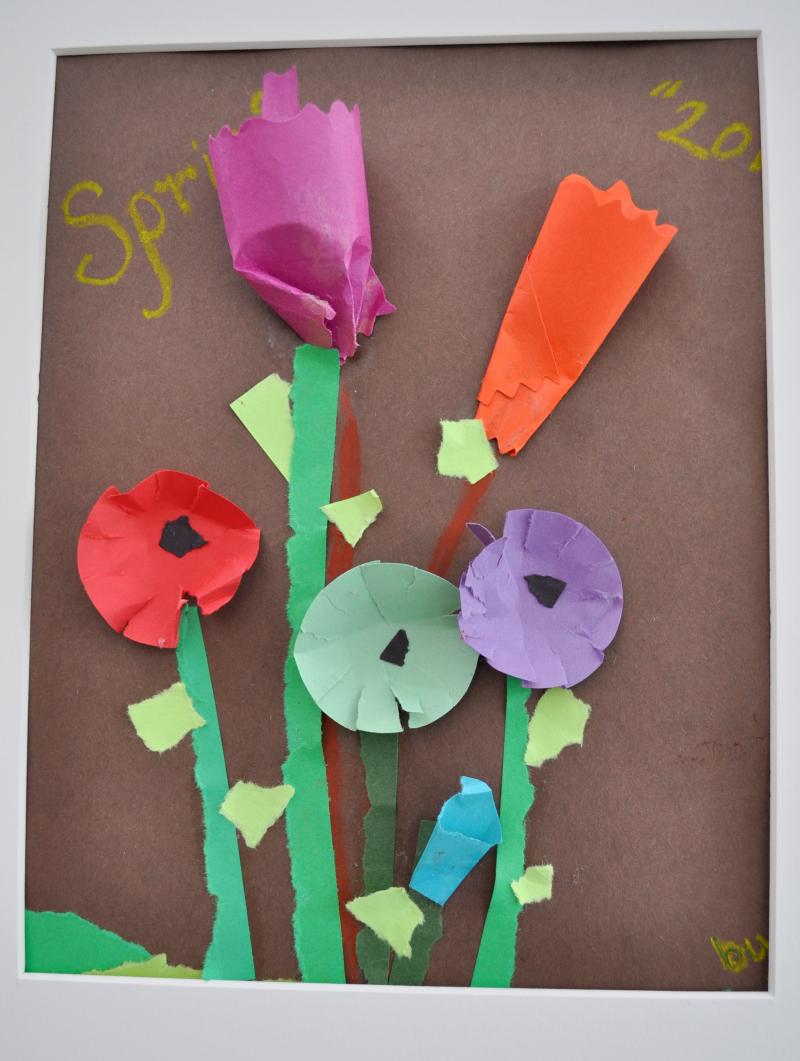 3D red, purple, and green paper flowers with stems on paper