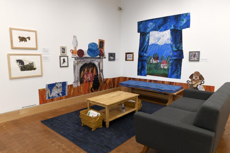 Installation image showing art framed on walls.