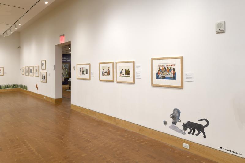 Installation image showing art framed on walls.