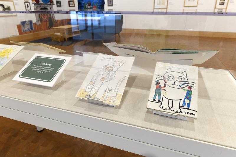 Installation image showing art framed on walls.