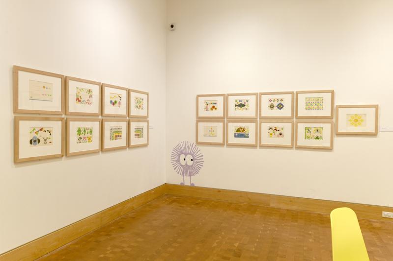 Installation image showing walls with framed art.