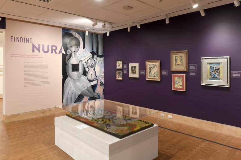 Installation image showing art framed on walls.