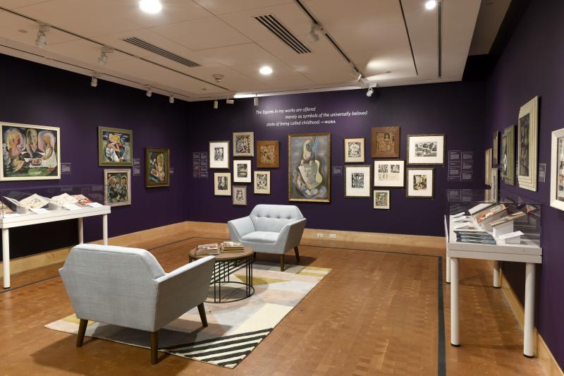 Installation image showing art framed on walls.