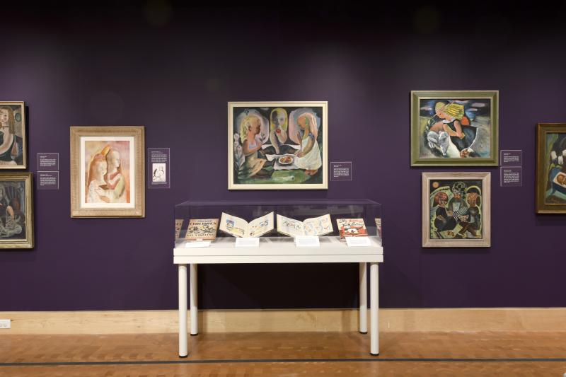 Installation image showing art framed on walls.
