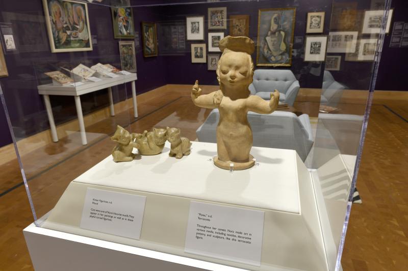 Installation image showing art framed on walls.