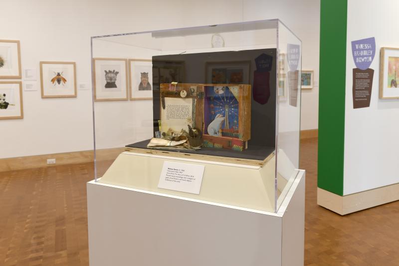 Installation image showing walls with framed art.