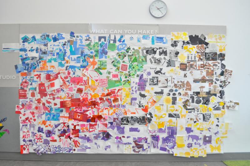A wall covered in colorful collages with some colors concentrated in certain areas.