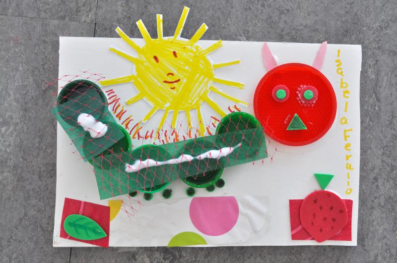 A mixed-media caterpillar collage with paper foods and a sun.