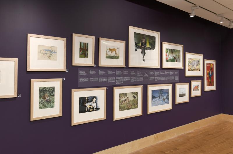 Installation image showing walls with framed art.