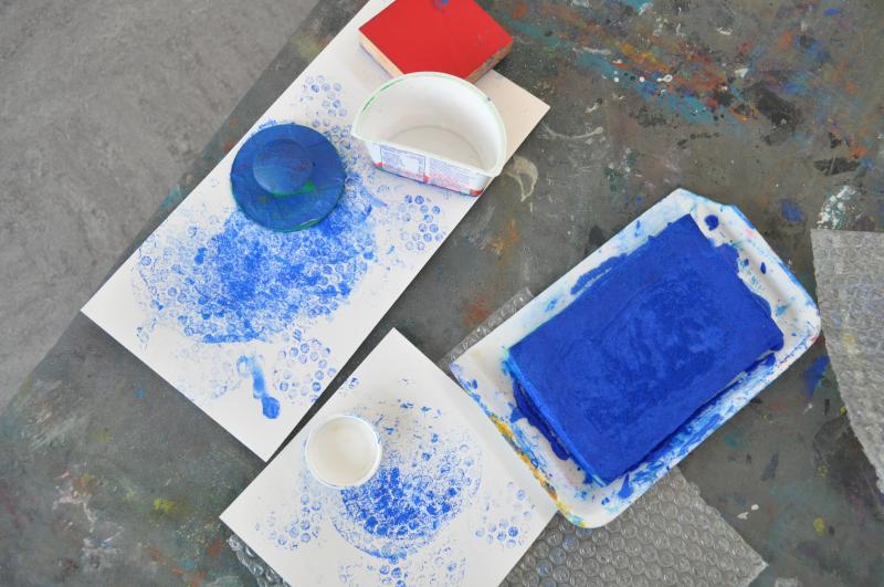 Papers covered in blue bubble wrap stamp marks.