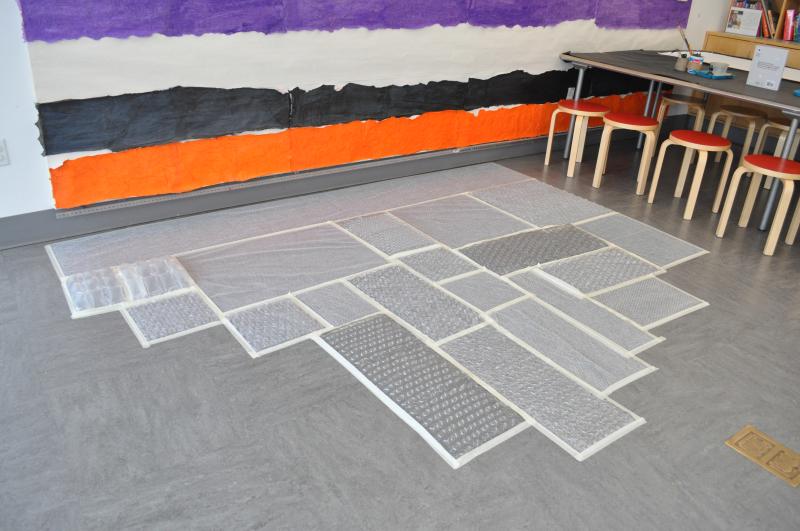 Bubble wrap sheets of different sizes taped onto the studio floor.
