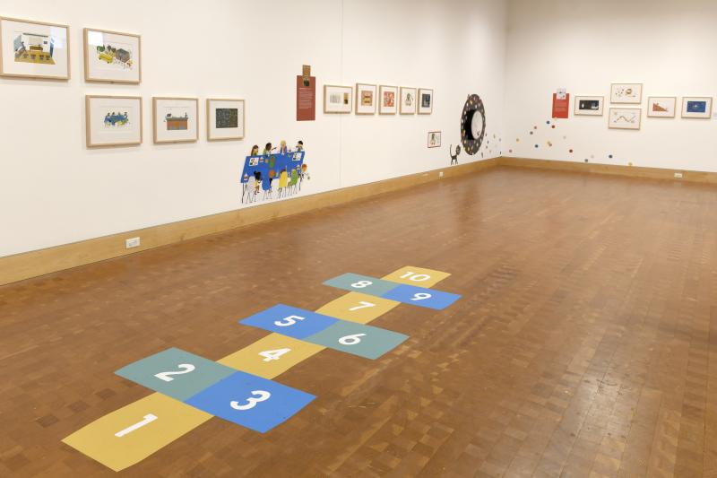Installation image showing walls with framed art.