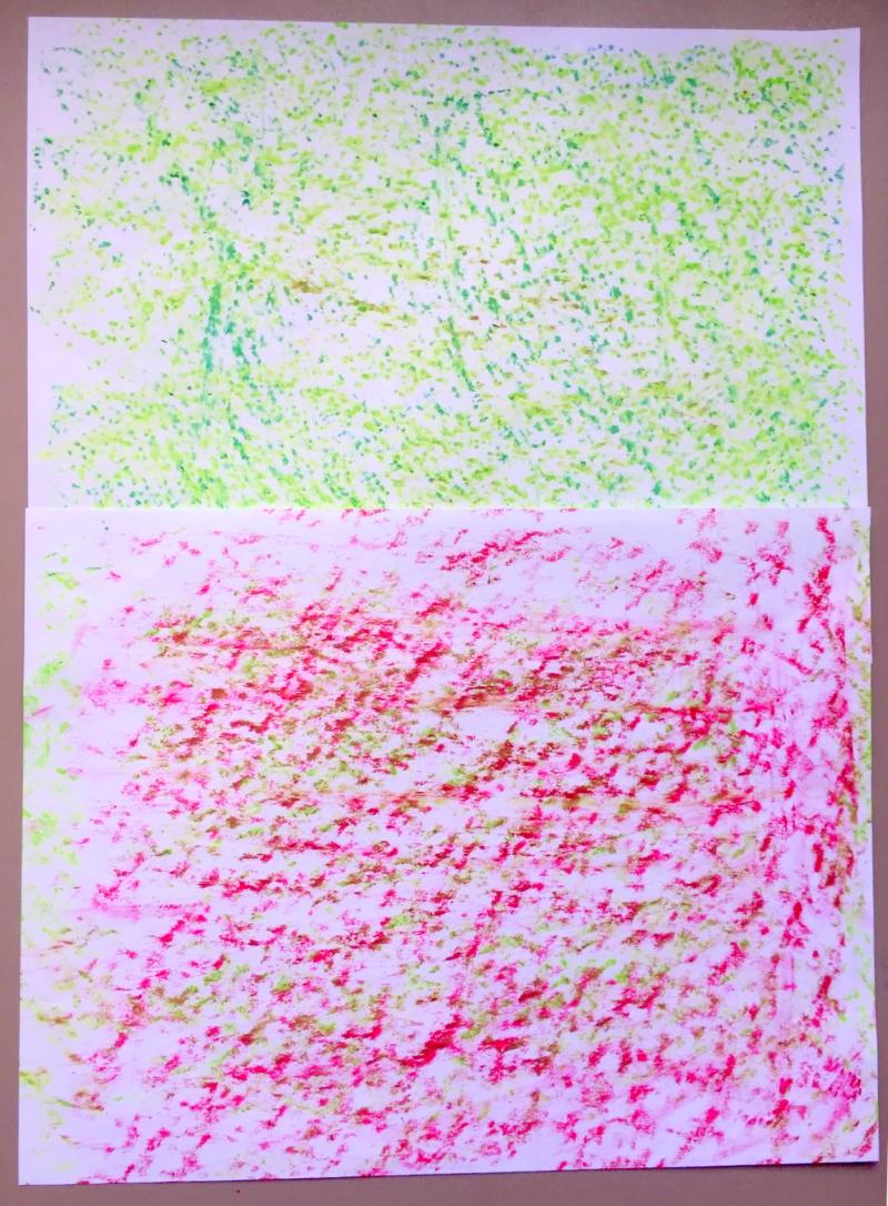 Two papers with texture rubbings on them showing slightly different patterns.