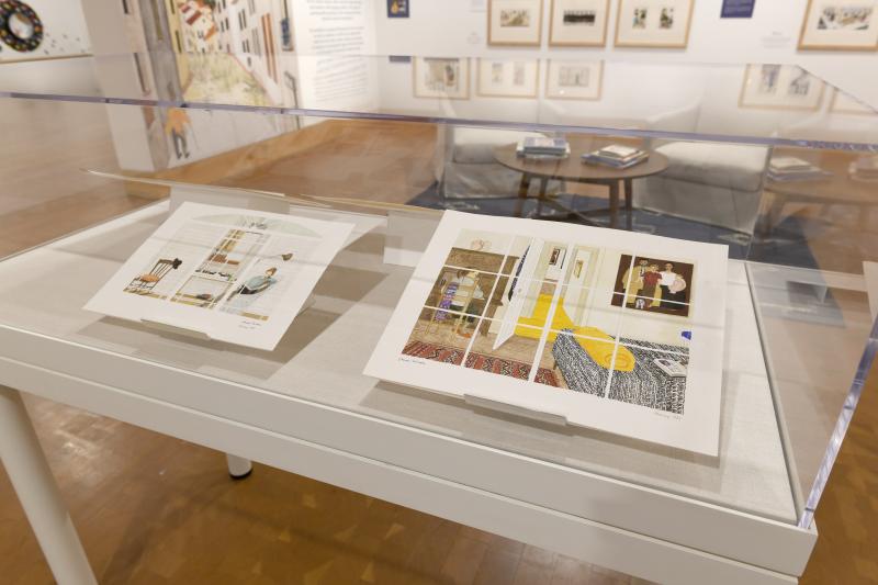 Photograph of gallery showing framed art and graphics.